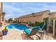 Backyard retreat featuring a sparkling pool, comfortable lounge chairs, and lush greenery for ultimate relaxation at 41737 W Cribbage Rd, Maricopa, AZ 85138