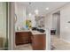 Home bar with granite counters, dark cabinetry, bar seating, and modern pendant lighting at 41737 W Cribbage Rd, Maricopa, AZ 85138