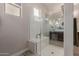 Bathroom featuring glass shower enclosure with bench, window, and modern fixtures at 41737 W Cribbage Rd, Maricopa, AZ 85138