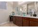 Bathroom vanity featuring granite counters, dark cabinetry, modern fixtures, and vanity seating at 41737 W Cribbage Rd, Maricopa, AZ 85138