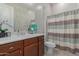 Bright bathroom with a shower, toilet, sink, vanity, and neutral paint at 41737 W Cribbage Rd, Maricopa, AZ 85138