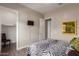 Cozy bedroom with a zebra-patterned bed, hardwood floors, and tv at 41737 W Cribbage Rd, Maricopa, AZ 85138
