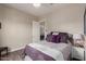 This bedroom features neutral paint, hardwood floors and purple bedding at 41737 W Cribbage Rd, Maricopa, AZ 85138