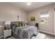 Stylish bedroom with zebra bedding, hardwood floors, chandelier and natural light at 41737 W Cribbage Rd, Maricopa, AZ 85138