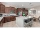 Open kitchen with stainless steel appliances, marble counters, a large island, and a dining area at 41737 W Cribbage Rd, Maricopa, AZ 85138