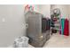 Laundry room with modern washer and dryer, storage shelving, and bright lighting at 41737 W Cribbage Rd, Maricopa, AZ 85138