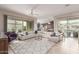 Spacious open-concept living room with seamless flow to kitchen, features lots of natural light at 41737 W Cribbage Rd, Maricopa, AZ 85138