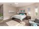 Main bedroom with hardwood floors, accent seating, large window with natural light, and accent lighting at 41737 W Cribbage Rd, Maricopa, AZ 85138
