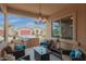 Inviting covered patio with outdoor kitchen, grill, and cozy seating area for relaxing and entertaining at 41737 W Cribbage Rd, Maricopa, AZ 85138
