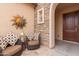 Cozy outdoor seating area with comfortable chairs and decorative wall art and stone accents at 41737 W Cribbage Rd, Maricopa, AZ 85138