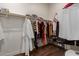 Spacious walk-in closet with ample storage, hanging rods, shelving, and dark flooring at 41737 W Cribbage Rd, Maricopa, AZ 85138