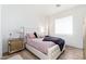 Bright bedroom with light pink bedspread, stylish lamps and a hardwood floor at 4438 N 27Th St # 24, Phoenix, AZ 85016