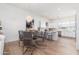 Open-concept dining area with a glass-top table, stylish chairs, and modern chandelier lighting at 4438 N 27Th St # 24, Phoenix, AZ 85016