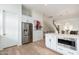 Bright kitchen featuring white cabinets, stainless steel appliances, and an eat-in kitchen island at 4438 N 27Th St # 24, Phoenix, AZ 85016