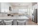 Bright, spacious kitchen featuring white cabinets, stainless steel appliances, and an eat-in kitchen island at 4438 N 27Th St # 24, Phoenix, AZ 85016