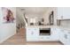Open-concept kitchen with white cabinets, stainless steel appliances, and an island with a built-in microwave at 4438 N 27Th St # 24, Phoenix, AZ 85016