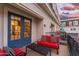 Outdoor patio with red cushioned chairs and a black metal coffee table at 4438 N 27Th St # 24, Phoenix, AZ 85016