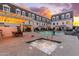 Community pool with lounge chairs in front of condo building with balconies and a brown roof at 4438 N 27Th St # 24, Phoenix, AZ 85016