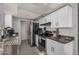 Well-lit kitchen with sleek countertops, modern appliances, and white cabinets at 4611 N 75Th Dr, Phoenix, AZ 85033