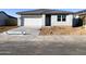 Single-story home featuring a low-pitched roof, light exterior paint, a white garage door, and minimal landscaping at 46940 W Coe St, Maricopa, AZ 85139