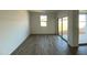 Bright living room featuring hardwood flooring and sliding glass doors leading to the patio at 46940 W Coe St, Maricopa, AZ 85139