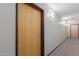 Hallway features neutral walls, carpet, and a door with unit number, offering a glimpse into the building's interior at 4808 N 24Th St # 906, Phoenix, AZ 85016