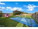 Beautiful backyard featuring a trampoline, playset, hammock under covered patio, and lush landscaping at 5172 S Seton Ave, Gilbert, AZ 85298
