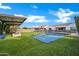 Expansive backyard featuring a large trampoline, pool with soccer goals, and covered patio at 5172 S Seton Ave, Gilbert, AZ 85298