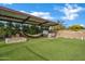 Backyard featuring artificial grass, fire pit, hammock, hot tub, and covered patio at 5172 S Seton Ave, Gilbert, AZ 85298