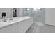 Bright bathroom with a double sink vanity, marble countertop, and glass-enclosed shower at 5172 S Seton Ave, Gilbert, AZ 85298