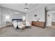 Well-lit bedroom with neutral colors, carpet, and a ceiling fan at 5172 S Seton Ave, Gilbert, AZ 85298