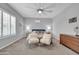 Well-lit primary bedroom with neutral colors, carpet, and a ceiling fan at 5172 S Seton Ave, Gilbert, AZ 85298