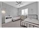 Charming ' bedroom with brick accent wall, ceiling fan, and neutral decor at 5172 S Seton Ave, Gilbert, AZ 85298