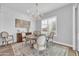 Bright dining room with chandelier, wainscoting, and a rustic wood table at 5172 S Seton Ave, Gilbert, AZ 85298