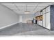 Spacious garage with epoxy floors and built-in white storage cabinets and workbench at 5172 S Seton Ave, Gilbert, AZ 85298
