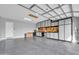 Spacious garage with epoxy floors and built-in white storage cabinets and workbench at 5172 S Seton Ave, Gilbert, AZ 85298