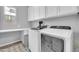 Laundry room with washer, dryer, white cabinets, and a window with natural light at 5172 S Seton Ave, Gilbert, AZ 85298