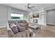 Cozy living room with modern fireplace, built-in shelving, and a large sectional sofa at 5172 S Seton Ave, Gilbert, AZ 85298