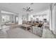 Spacious living room with ample seating, wood floors, and an open layout to the kitchen at 5172 S Seton Ave, Gilbert, AZ 85298