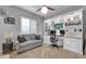 Home office featuring built-in bookshelves, modern desk setup, and comfortable seating area at 5172 S Seton Ave, Gilbert, AZ 85298