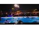 Backyard pool with people enjoying firework display at night at 5172 S Seton Ave, Gilbert, AZ 85298