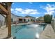 Sparkling pool with a fountain feature, surrounded by a safety fence and lush landscaping at 5172 S Seton Ave, Gilbert, AZ 85298