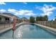 Sparkling pool with a fountain feature, surrounded by a safety fence and lush landscaping at 5172 S Seton Ave, Gilbert, AZ 85298
