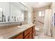 Neutral bathroom featuring a vanity with granite top and a shower-tub combo at 6409 E Duncan St, Mesa, AZ 85205