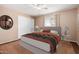 Cozy bedroom featuring a large bed with a ceiling fan and a double closet at 6409 E Duncan St, Mesa, AZ 85205