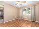 Empty bedroom featuring neutral walls, wood floors, a ceiling fan, and a window at 6409 E Duncan St, Mesa, AZ 85205