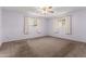 Bedroom features neutral paint, carpet, a ceiling fan, and two windows at 6409 E Duncan St, Mesa, AZ 85205