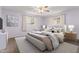 Bedroom features a large bed, neutral walls and carpeting, and white-trimmed windows at 6409 E Duncan St, Mesa, AZ 85205