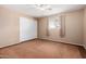 Bedroom with neutral paint and carpet features double closet, and a ceiling fan at 6409 E Duncan St, Mesa, AZ 85205