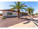 Inviting single-story home featuring desert landscaping, mature palms, and a sidewalk leading to the entrance at 6409 E Duncan St, Mesa, AZ 85205